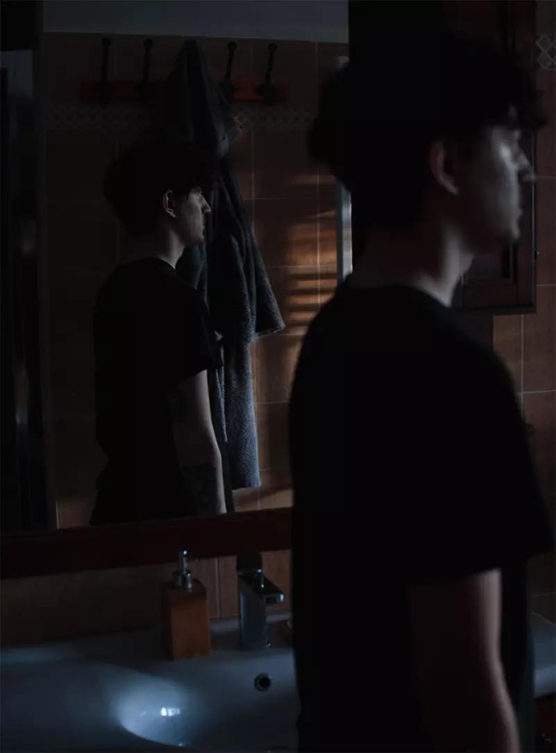 A man standing in front of a mirror